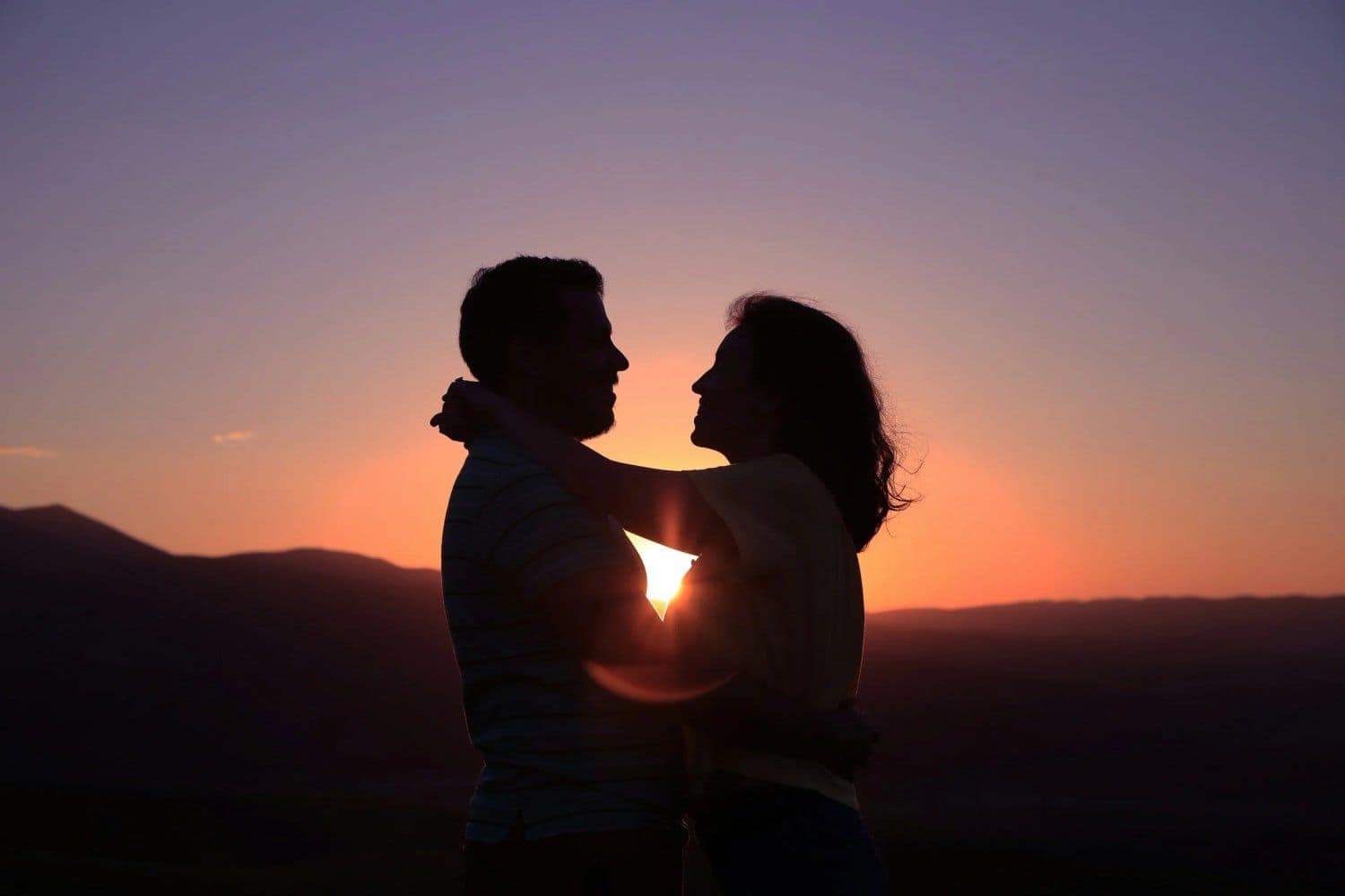 A couple embracing at sunset